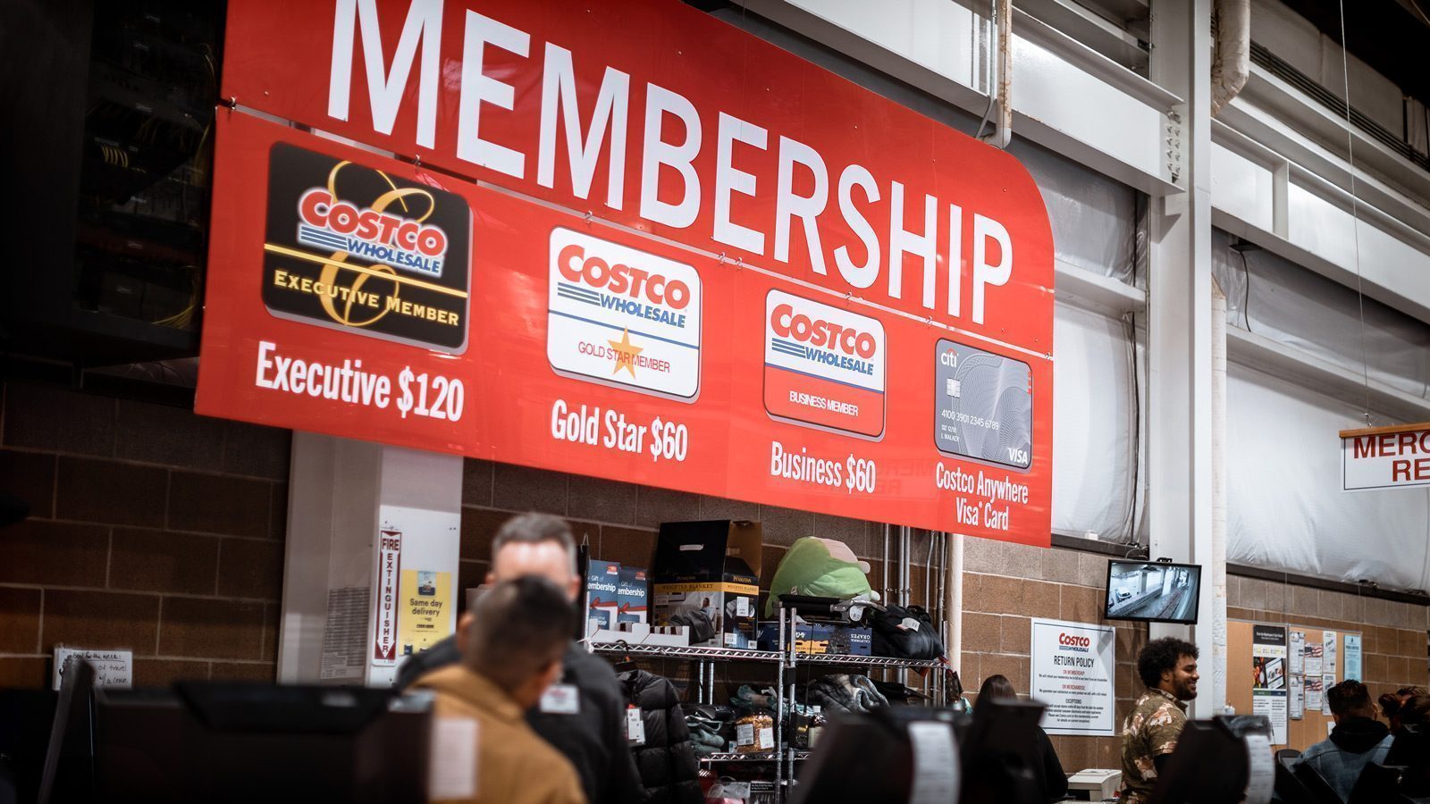 Sign at Costco showing membership levels and current fees.