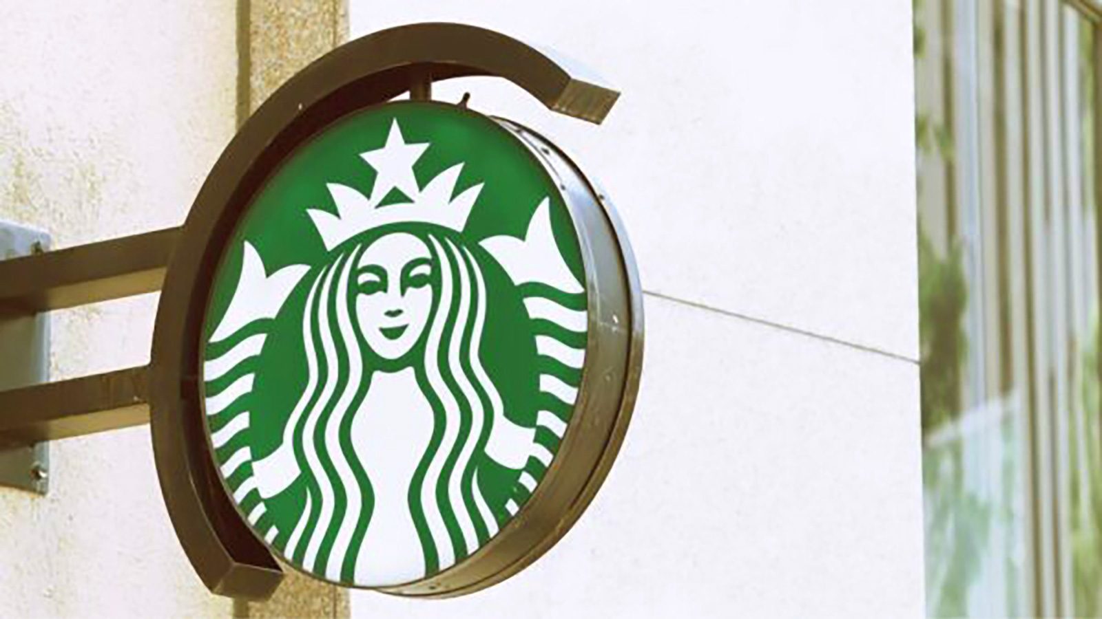 The iconic round green Starbucks logo, adorned with the white siren design, stands mounted on a wall, creating a familiar beacon for coffee lovers. This carefully positioned emblem not only welcomes guests but also serves as an effective tool in optimizing SEO keywords for shrinking digital spaces.